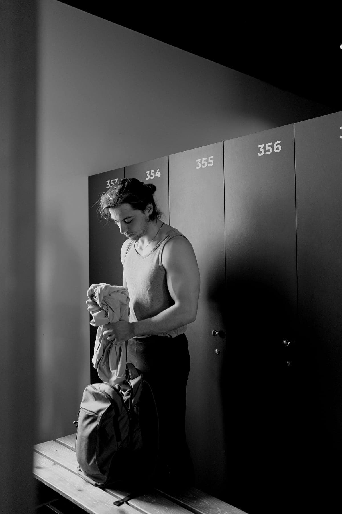 A member gets ready at the lockers before a class.